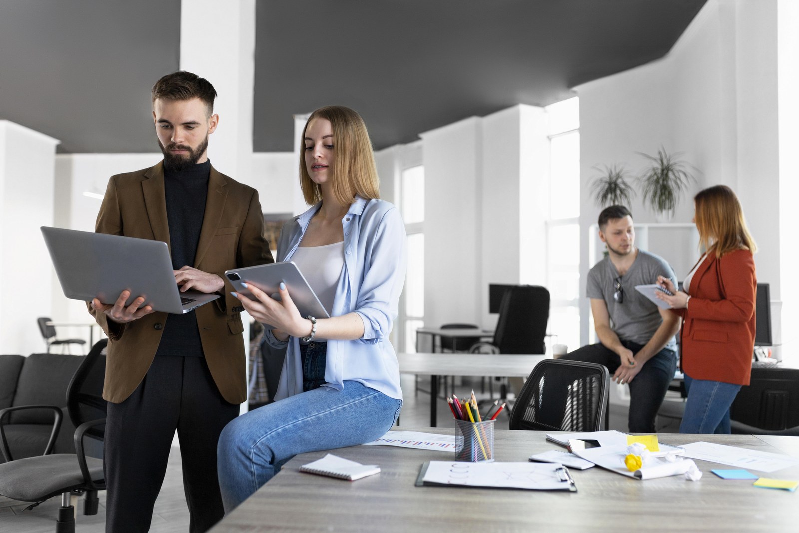 Colleagues in a modern office discussing AI adoption and Copilot ROI using the 2026 Work Trend Index findings